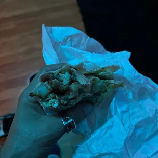 a person holding a burrito