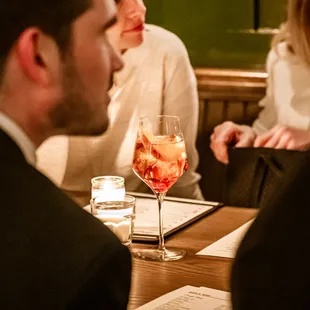 a cocktail and a group of friends