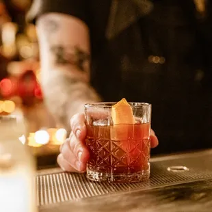 a person holding a glass of alcohol