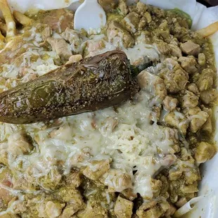 Super fries with green salsa and pork.