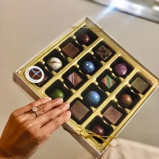 Me awkwardly holding a box of chocolates to show off my ring haha