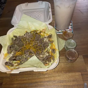 This is their carne asada fries with a large horchata and the 3 hot sauces.