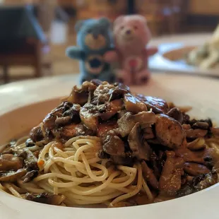 a plate of spaghetti with mushrooms and mushrooms