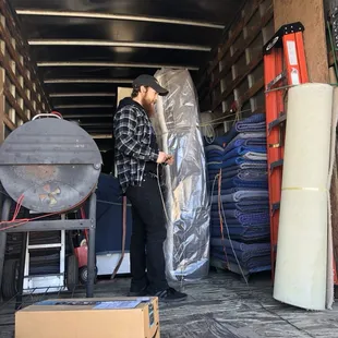 Organizing customers furniture on truck.