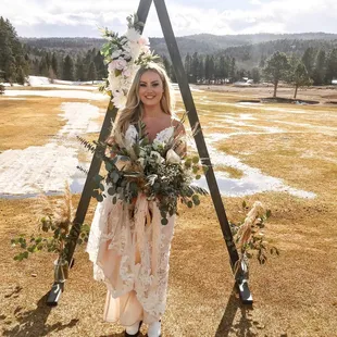 My wedding bouquet of my dreams! It had a mixture of eucalyptus, roses, pampas grass, baby's breath, and a lot more texture and beauty!