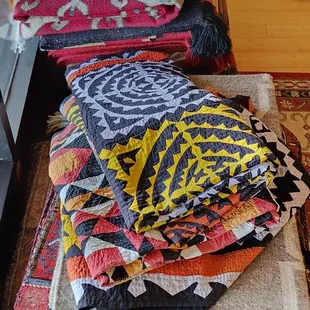 Some patchwork pieces as well as woven rugs.
