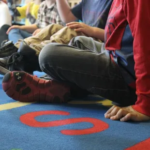 Preschoolers sitting down for story time