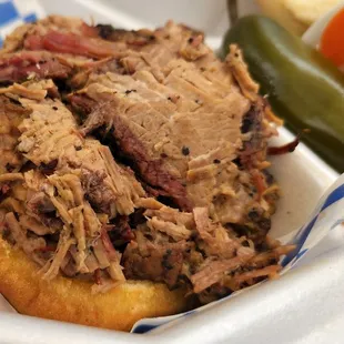Smoked BBQ beef brisket sandwich close up.