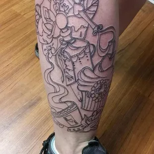 Outline of an Alice in Wonderland inspired leg tattoo from James.