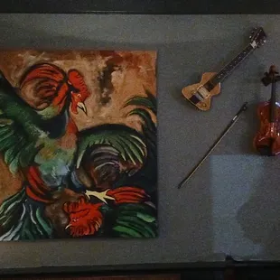 a painting of a rooster and guitar