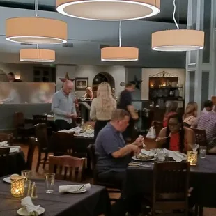 a large group of people eating in a restaurant