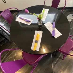 a table with purple chairs