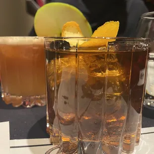 a glass of iced tea with a lemon garnish