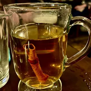 a cup of tea with a cinnamon stick in it