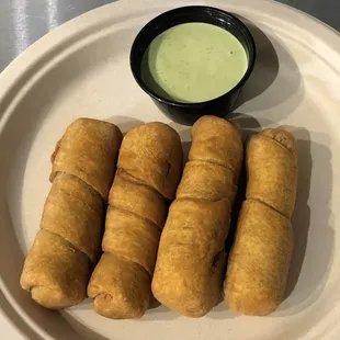 Venezuelan cheese sticks with cilantro sauce