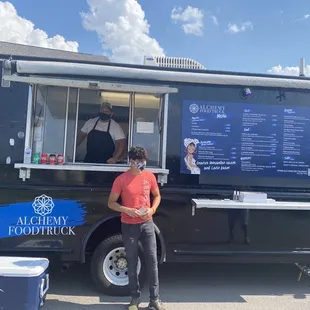 a man standing in front of a food truck
