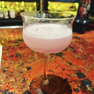 a drink in a glass on a bar