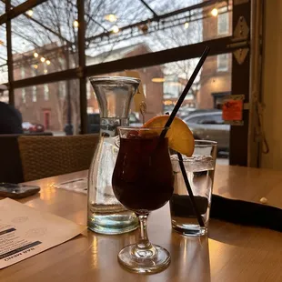 a glass of wine and a drink on a table