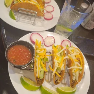 two plates of tacos and salsa