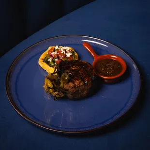 a plate of food on a blue table