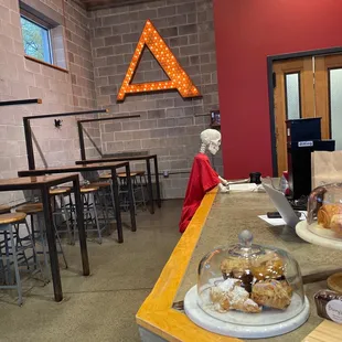 a little boy looking at pastries on a counter