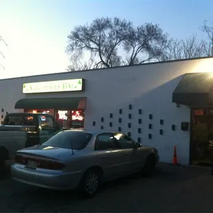 a car parked in front of a bar