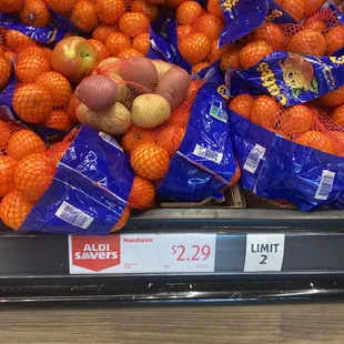 oranges and potatoes on display in a grocery store