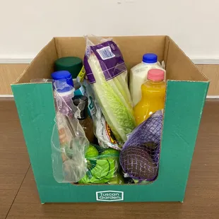 a cardboard box filled with groceries