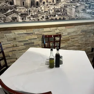 a table with two bottles of olive oil on it