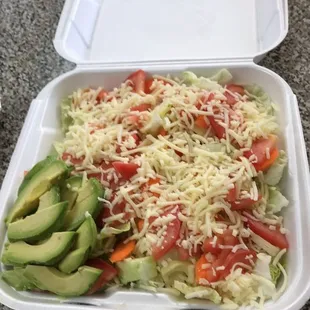 a salad in a styrofoam container