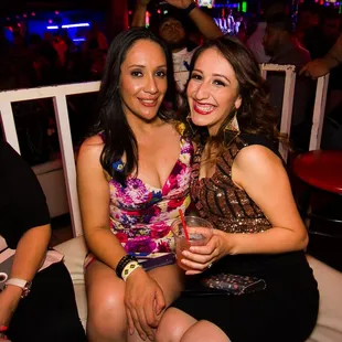 two women sitting on a chair