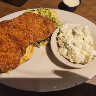 Breaded tenderlion sandwhich and potato salad.