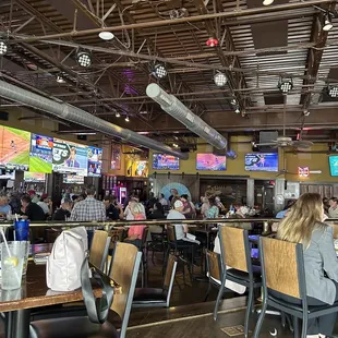 people sitting at tables in a restaurant