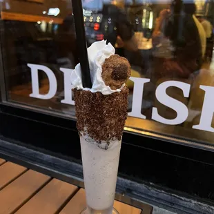 a milkshake with a donut on top