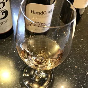 a glass of wine and a bottle of wine