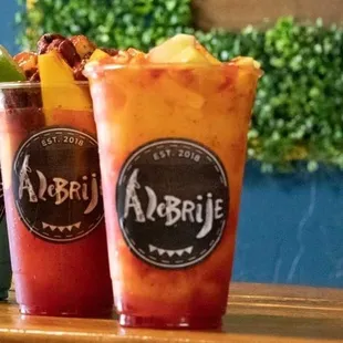 two glasses of alebrije on a table