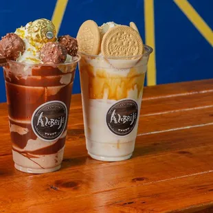 two ice cream sundaes on a wooden table