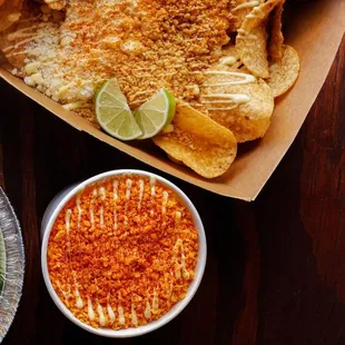 a box of chips and a bowl of salsa