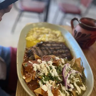 Rib eye steak with red and green chilaquiles and eggs