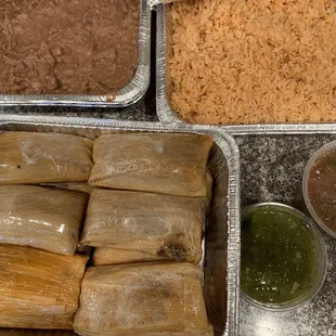 Red pork tamales, frijoles, arroz, salsita verde y rojo. Delicious!