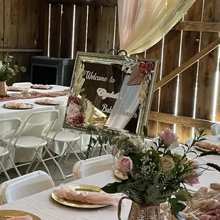 2023 Turn-key baby shower... welcome Mirror and fresh floral centerpieces in hammered copper pitchers
