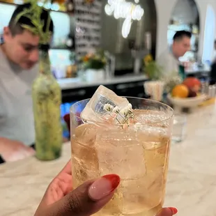 a person holding a glass of alcohol