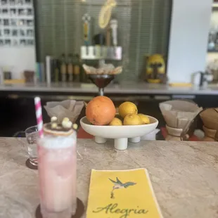 a drink and a menu on a table