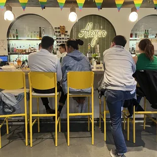 a group of people sitting at a bar