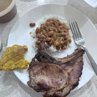 Pork chops and rice and beans.