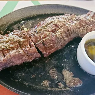 Grilled skirt steak with a very tasty chimichurri sauce - The plate was still sizzling. I'd already eaten a chunk of the steak.