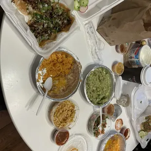 carne asada tacos, rice and beans, street corn, guacamole, pico, salsas