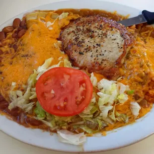 Pork steak and enchilada combo