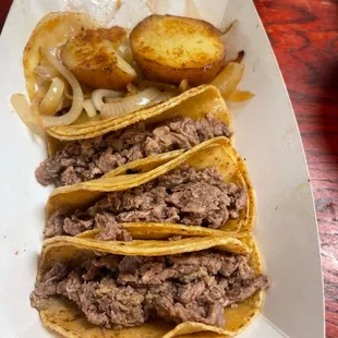 a plate of tacos and potatoes