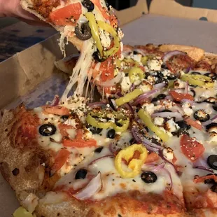 Medium Greek pizza. Look at all the beautiful veggies and feta!